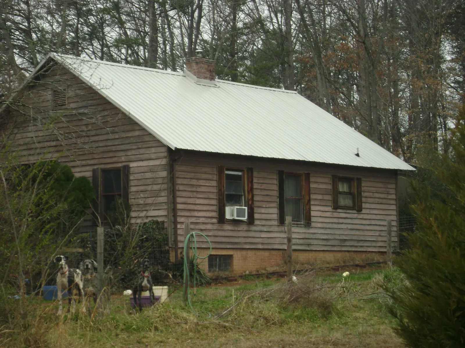 White metal roof on an old wood sided farmhouse, from a Metal Roof Installation job in North Granby